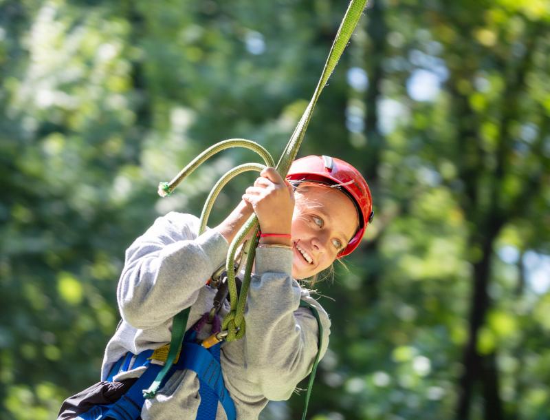 After a helping hand from her classmates, Olivia Stone enjoys the big swing.
